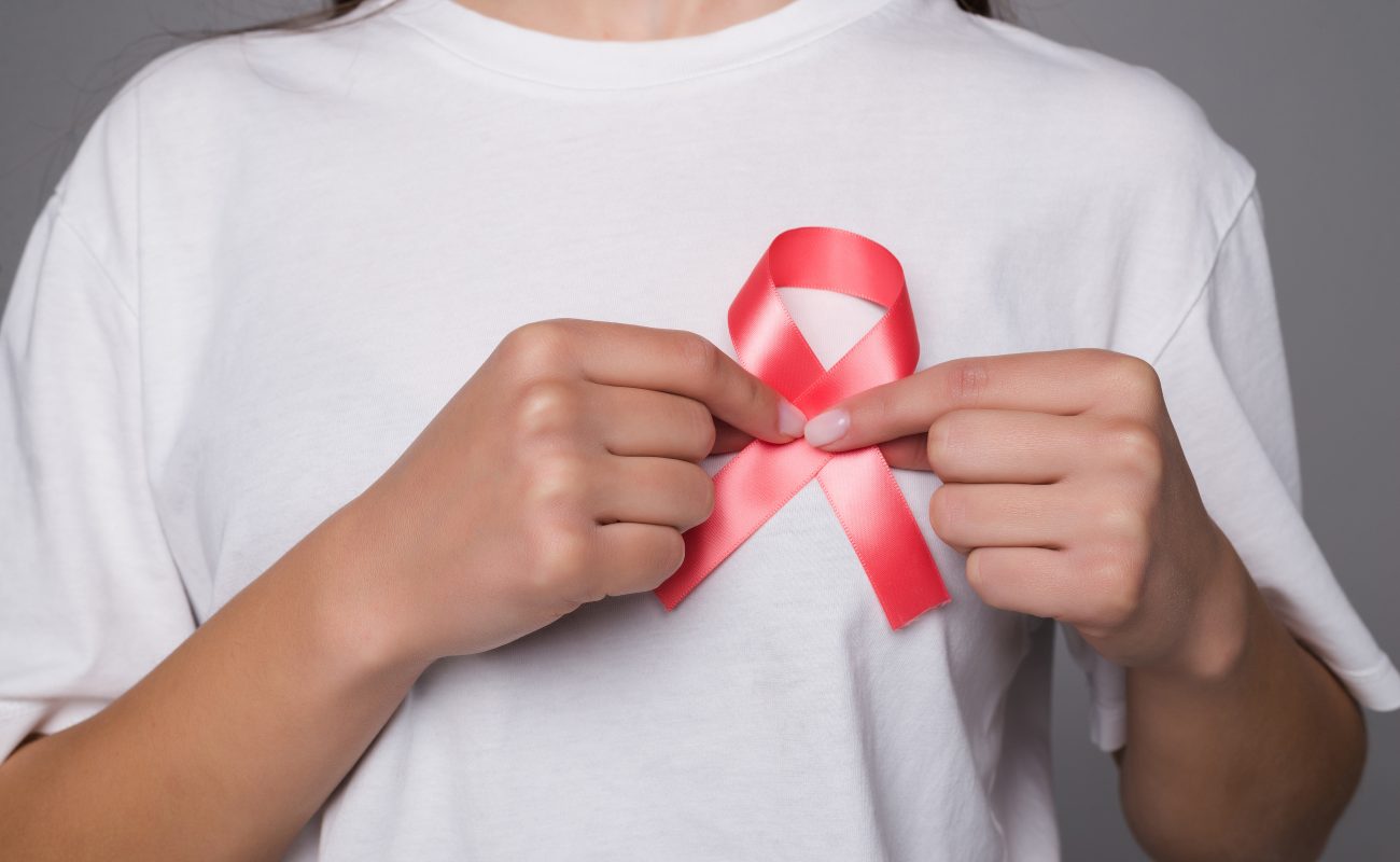 World Breast Cancer Day Concept,health care - woman wore white t-shirt with Pink ribbon for awareness, symbolic bow color raising on people living with women's breast tumor illness